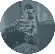 Person sitting with a hand on their forehead